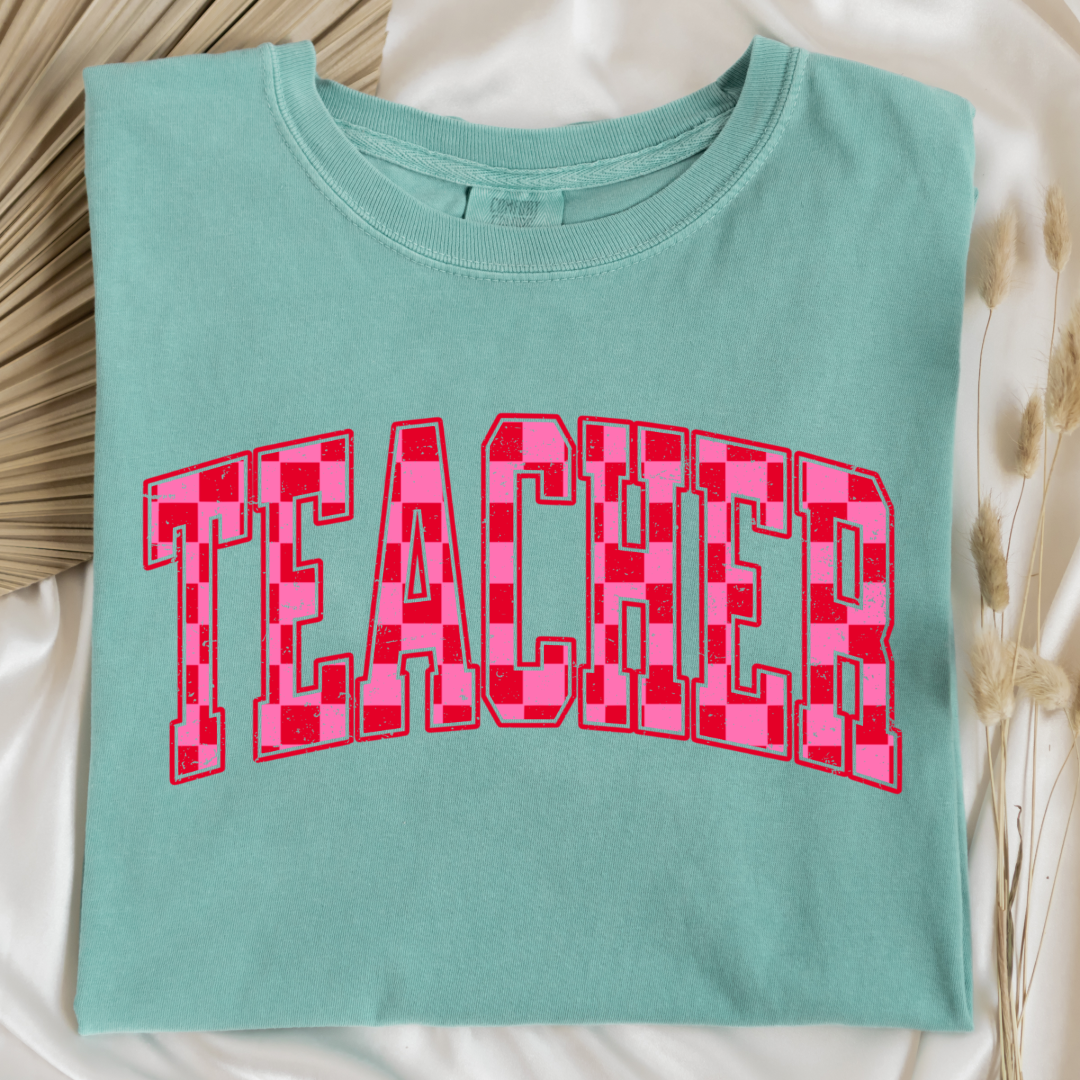 Customized Adult Chalky Mint Graphic tee with pink and red checkered teacher varsity font.