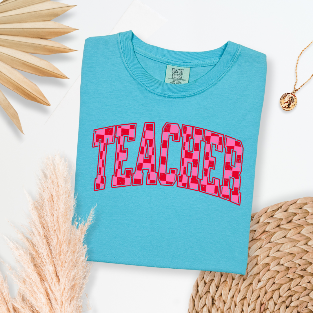 Customized Adult Lagoon Blue Graphic tee with pink and red checkered teacher varsity font