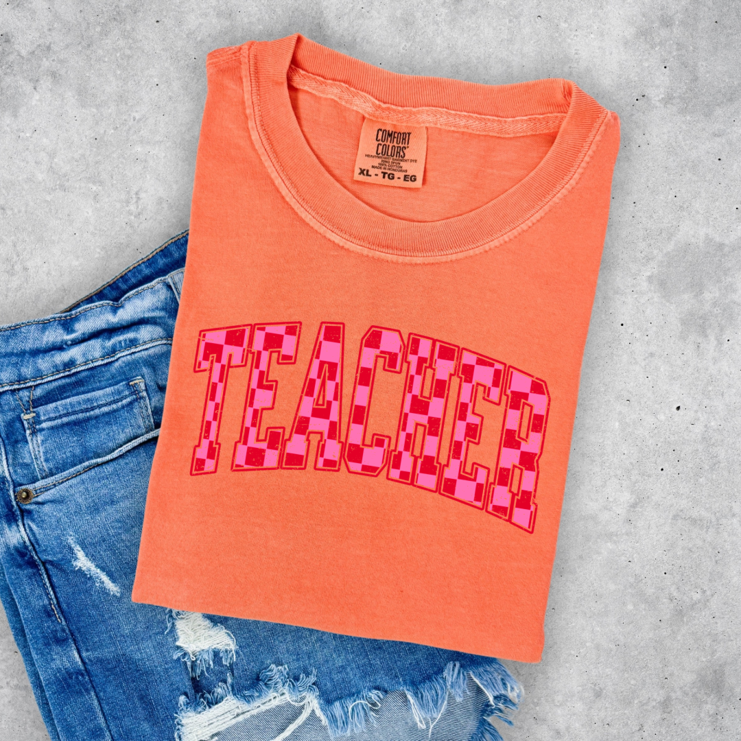 Customized Adult Melon Orange Graphic tee with pink and red checkered teacher varsity font
