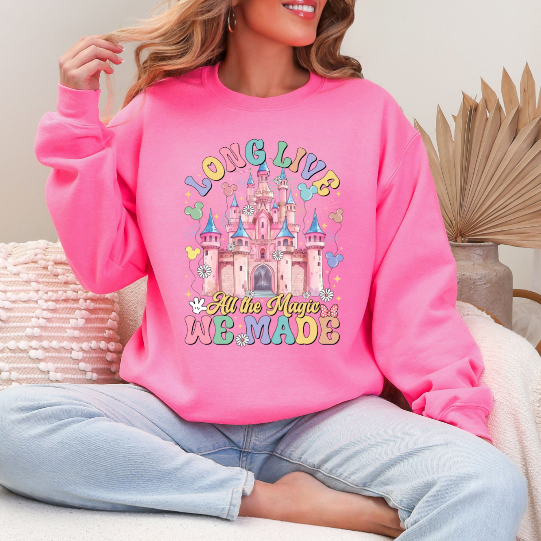 Customized Adult Safety pink crewneck with long live multi color long live bubble letters large castle in the middle with Mickey Mouse shaped balloons and flowers surrounding. Matching t-shirts and hoodies available in youth and adult sizes