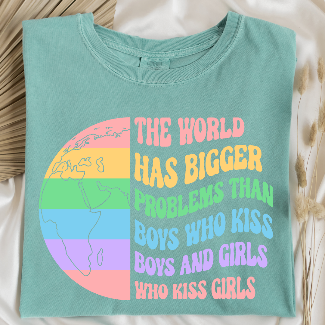 Customized Adult comfort colors Chalky Mint Graphic tee. Split image rainbow world map on one side and quote " the world has bigger problems than boys who kiss boys. and girls who kiss girls" on the other matching adult crewnecks and hoodies available. Perfect for Pride month,