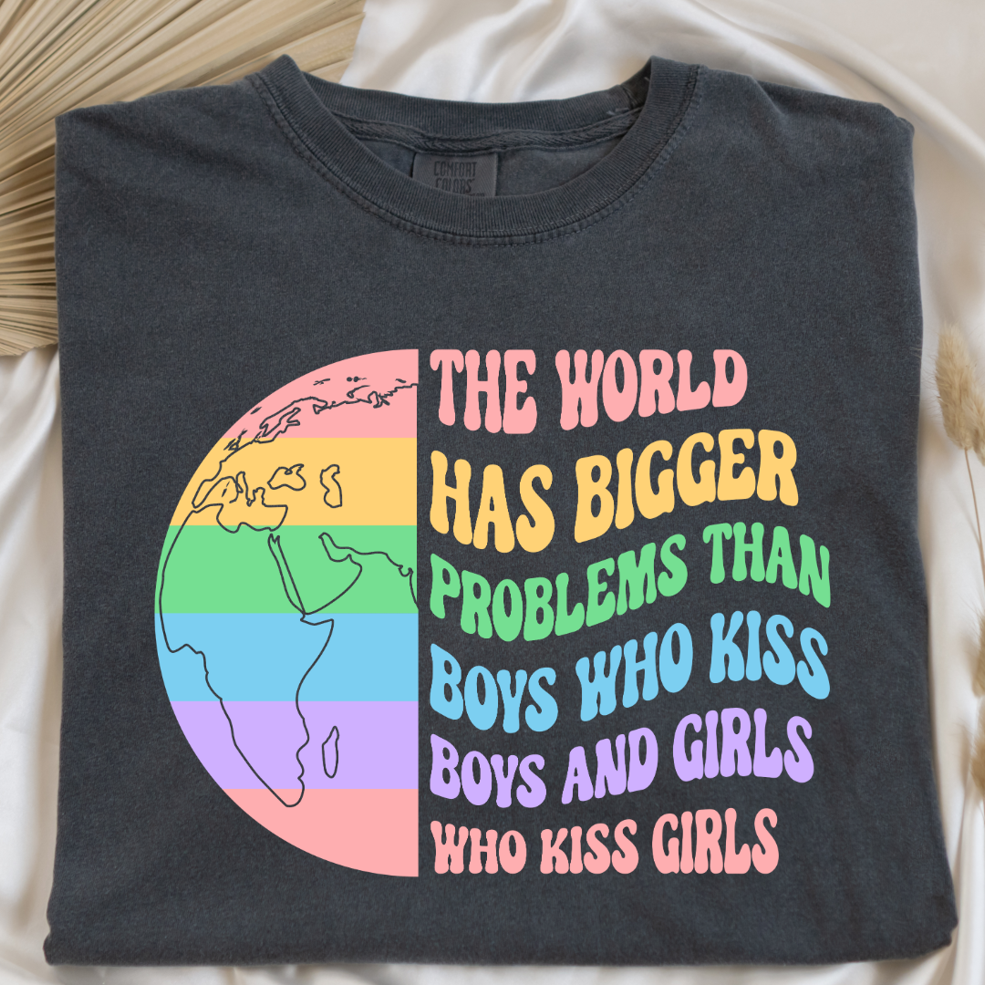 Customized Adult comfort colors Pepper vintage black Graphic tee. Split image rainbow world map on one side and quote " the world has bigger problems than boys who kiss boys. and girls who kiss girls" on the other matching adult crewnecks and hoodies available. Perfect for Pride month,