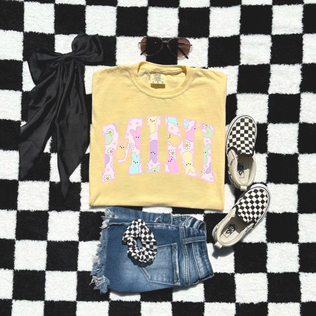 Customized youth mini of a mama and mini matching set varsity lettering with Patel peeps on the inside of the lettering matching youth crewneck available comfort colors butter yellow graphic tee