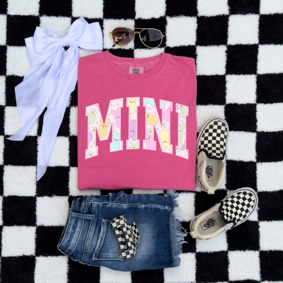 Customized youth mini of a mama and mini matching set varsity lettering with Patel peeps on the inside of the lettering matching youth crewneck available comfort colors crunchberry pink graphic tee