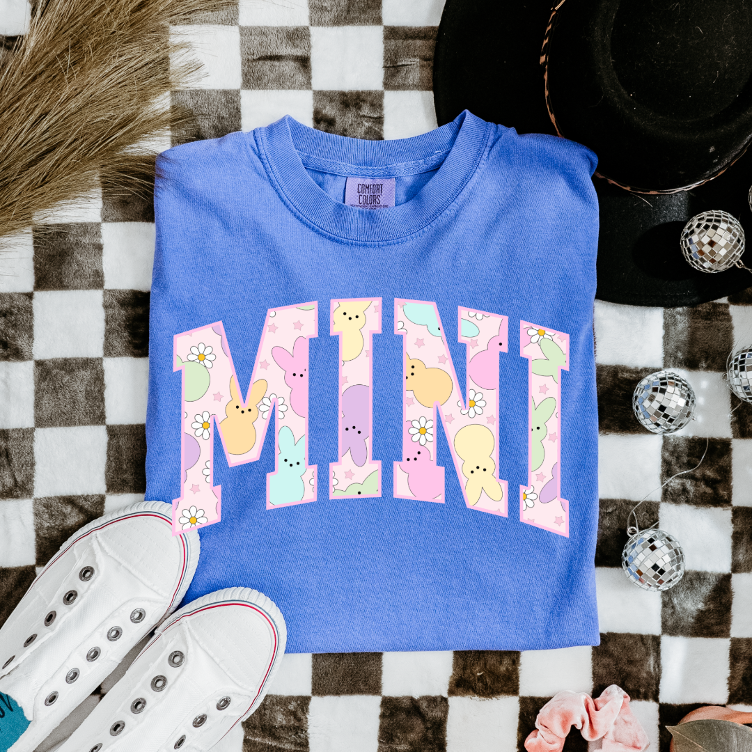 Customized youth mini of a mama and mini matching set varsity lettering with Patel peeps on the inside of the lettering matching youth and adult crewnecks available comfort colors flo blue graphic tee
