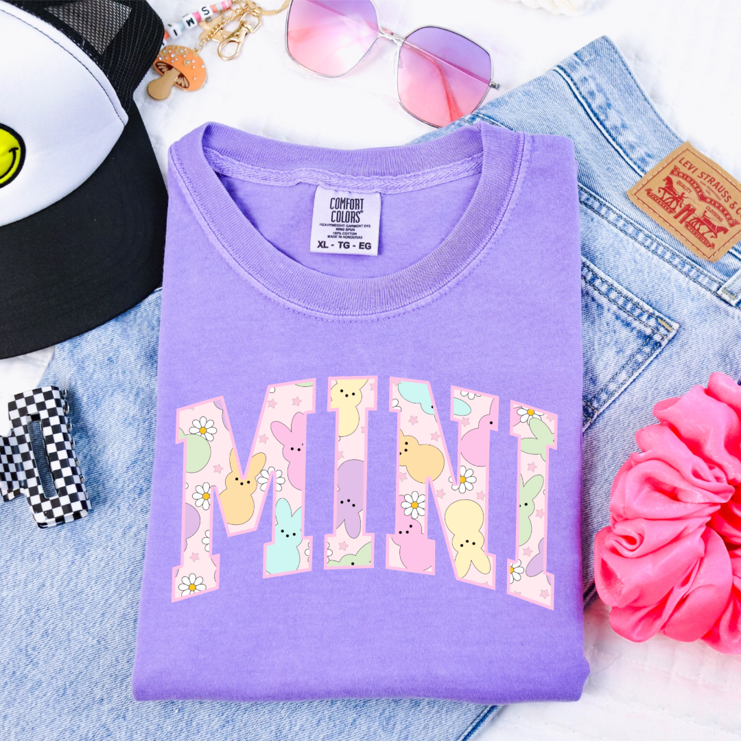 Customized youth mini of a mama and mini matching set varsity lettering with Patel peeps on the inside of the lettering matching youth crewnecks available comfort colors violet graphic tee