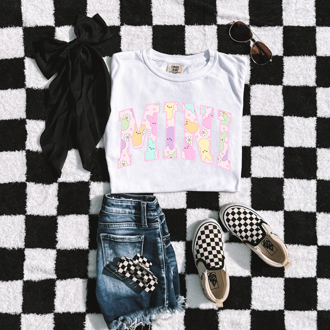 Customized youth mini of a mama and mini matching set varsity lettering with Patel peeps on the inside of the lettering matching youth crewnecks available comfort colors white graphic tee