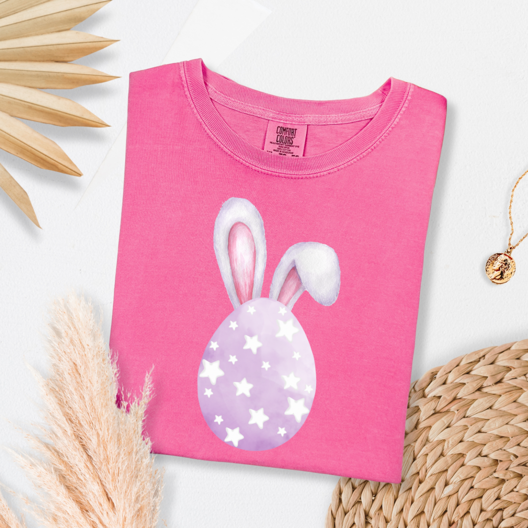 Customized adult comfort colors crunchberry pink graphic tee with purple watercolor egg with white stars matching crewneck and hoodies available in youth and adult sizes