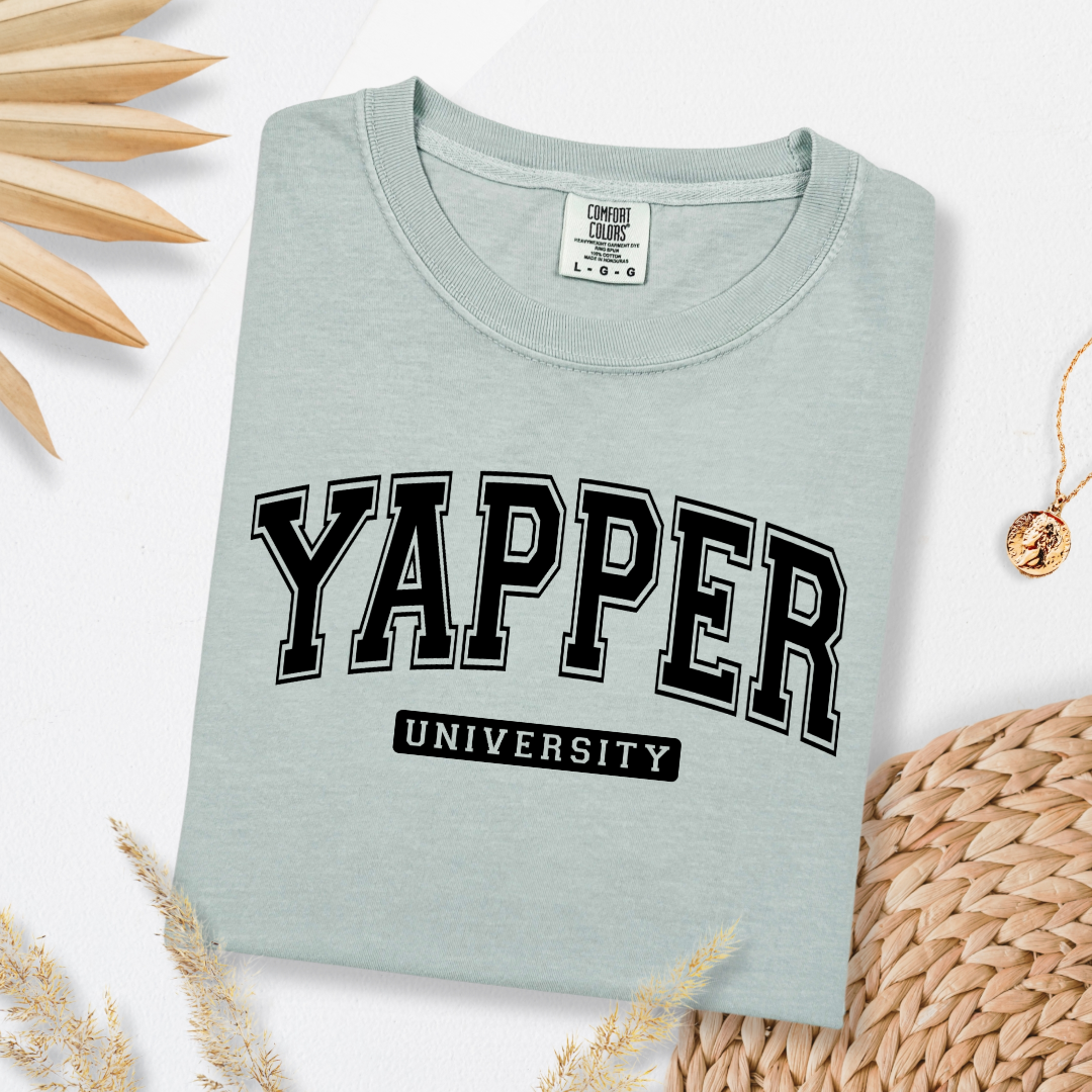 Customized adult comfort colors Bay green Graphic tee with black varsity lettering yapper university Matching hoodies and crewnecks in adult and youth sizes available.