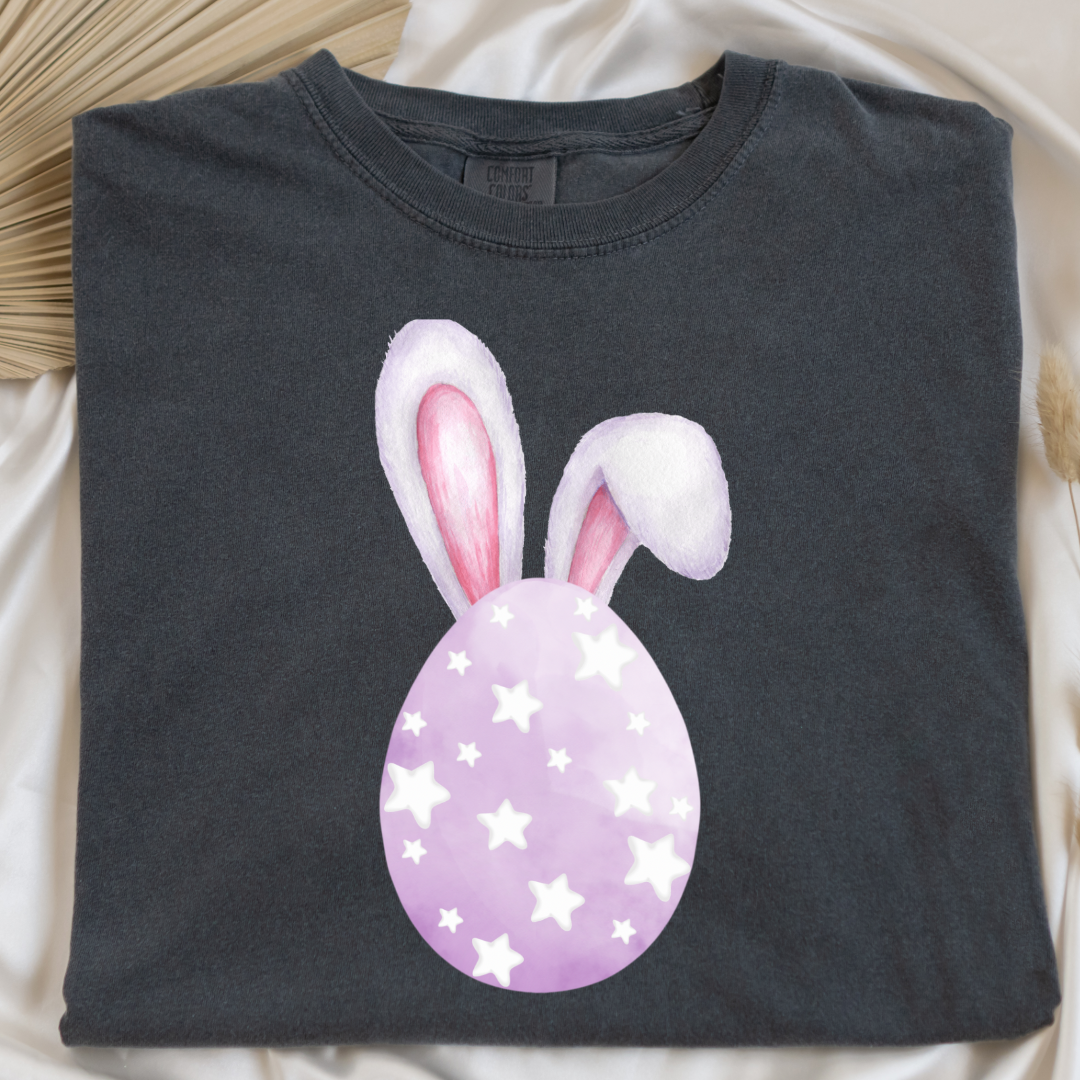 Customized adult comfort colors pepper vintage black graphic tee with purple watercolor egg with white stars matching crewneck and hoodies available in youth and adult sizes