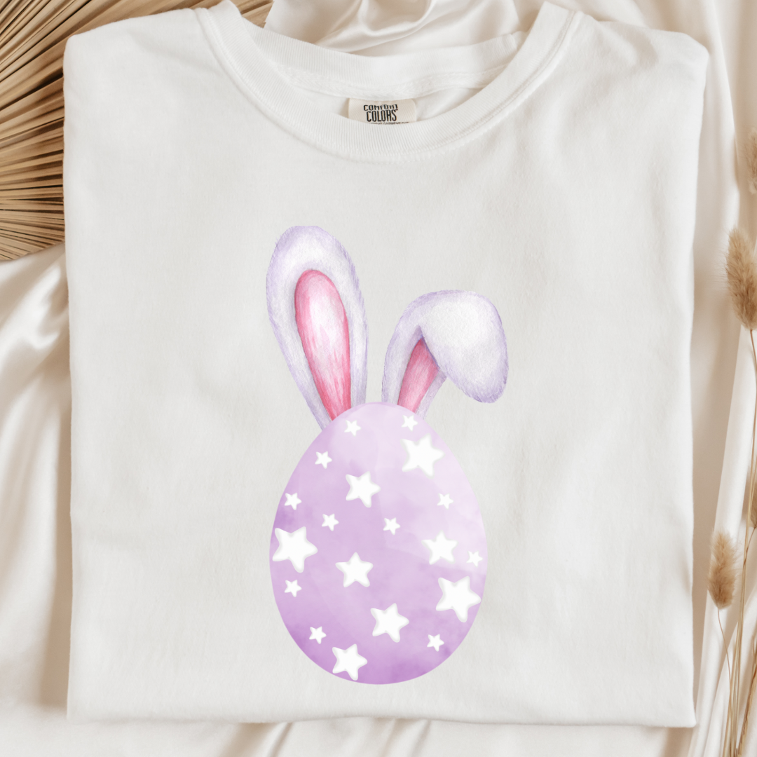 Customized adult comfort colors white graphic tee with purple watercolor egg with white stars matching crewneck and hoodies available in youth and adult sizes