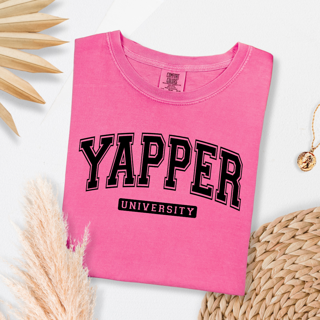 Customized adult comfort colors Crunchberry Pink Graphic tee with black varsity lettering yapper university Matching hoodies and crewnecks in adult and youth sizes available.
