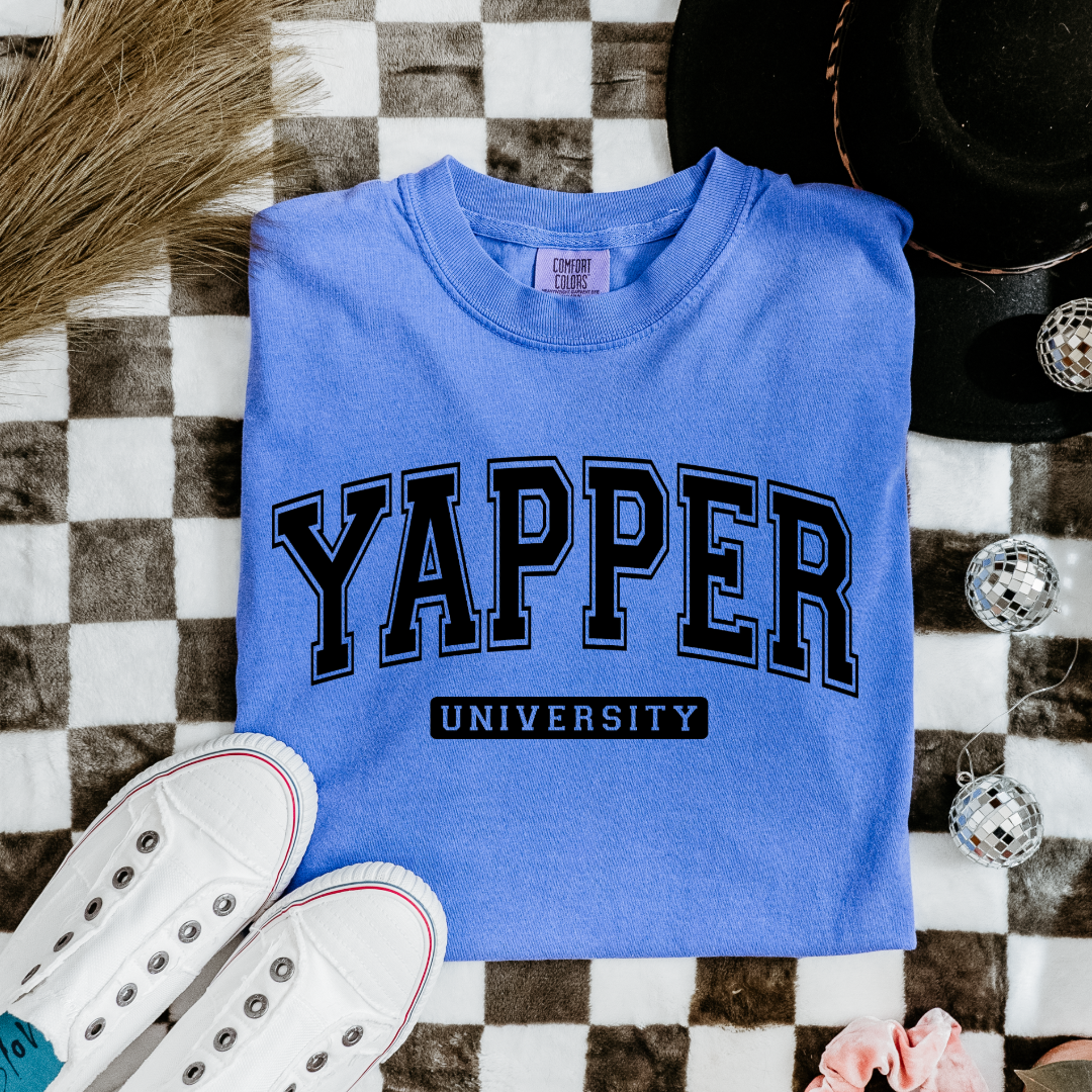 Customized adult/ youth comfort colors Flo blue Graphic tee with black varsity lettering yapper university Matching hoodies and crewnecks in adult and youth sizes available.