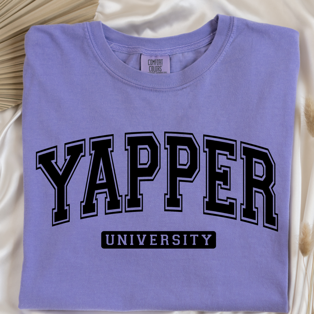 Customized adult comfort colors Violet Graphic tee with black varsity lettering yapper university Matching hoodies and crewnecks in adult and youth sizes available.
