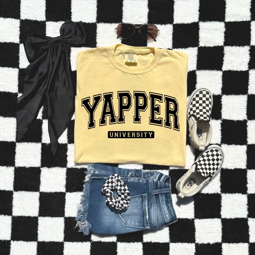Customized Youth comfort colors Butter yellow Graphic tee with black varsity lettering yapper university Matching hoodies and crewnecks in adult and youth sizes available.