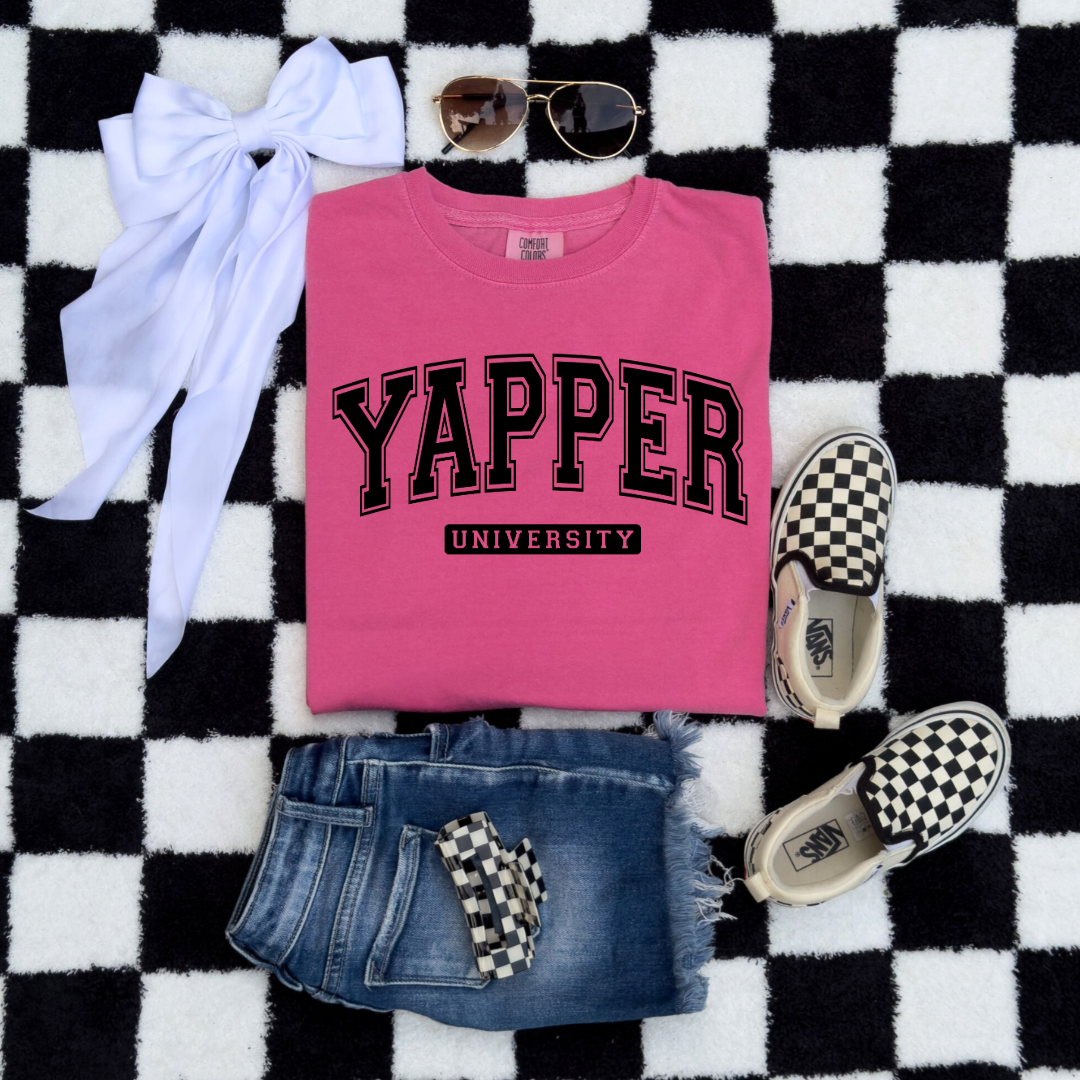 Customized Youth comfort colors Crunchberry Pink Graphic tee with black varsity lettering yapper university Matching hoodies and crewnecks in adult and youth sizes available.