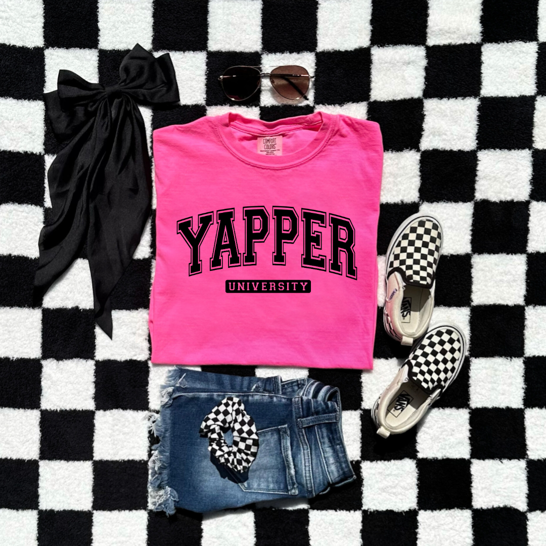 Customized Youth comfort colors Neon Pink Graphic tee with black varsity lettering yapper university Matching hoodies and crewnecks in adult and youth sizes available.