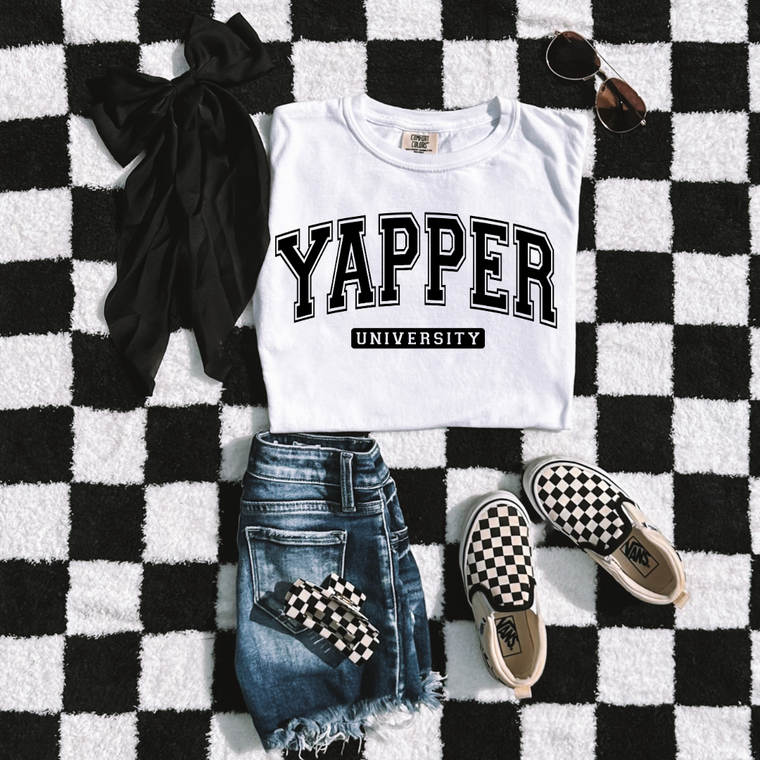 Customized Youth comfort colors White Graphic tee with black varsity lettering yapper university Matching hoodies and crewnecks in adult and youth sizes available.