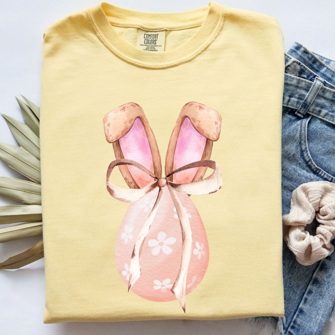 Customized adult comfort colors butter yellow watercolor peach egg with white flowers and brown floppy skinny bow and bunny ears matching crewneck and hoodies available In adult and youth sizes