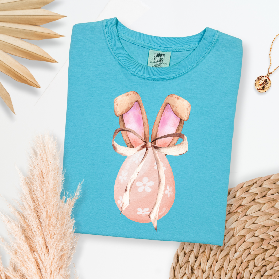 Customized adult comfort colors lagoon blue watercolor peach egg with white flowers and brown floppy skinny bow and bunny ears matching crewneck and hoodies available In adult and youth sizes