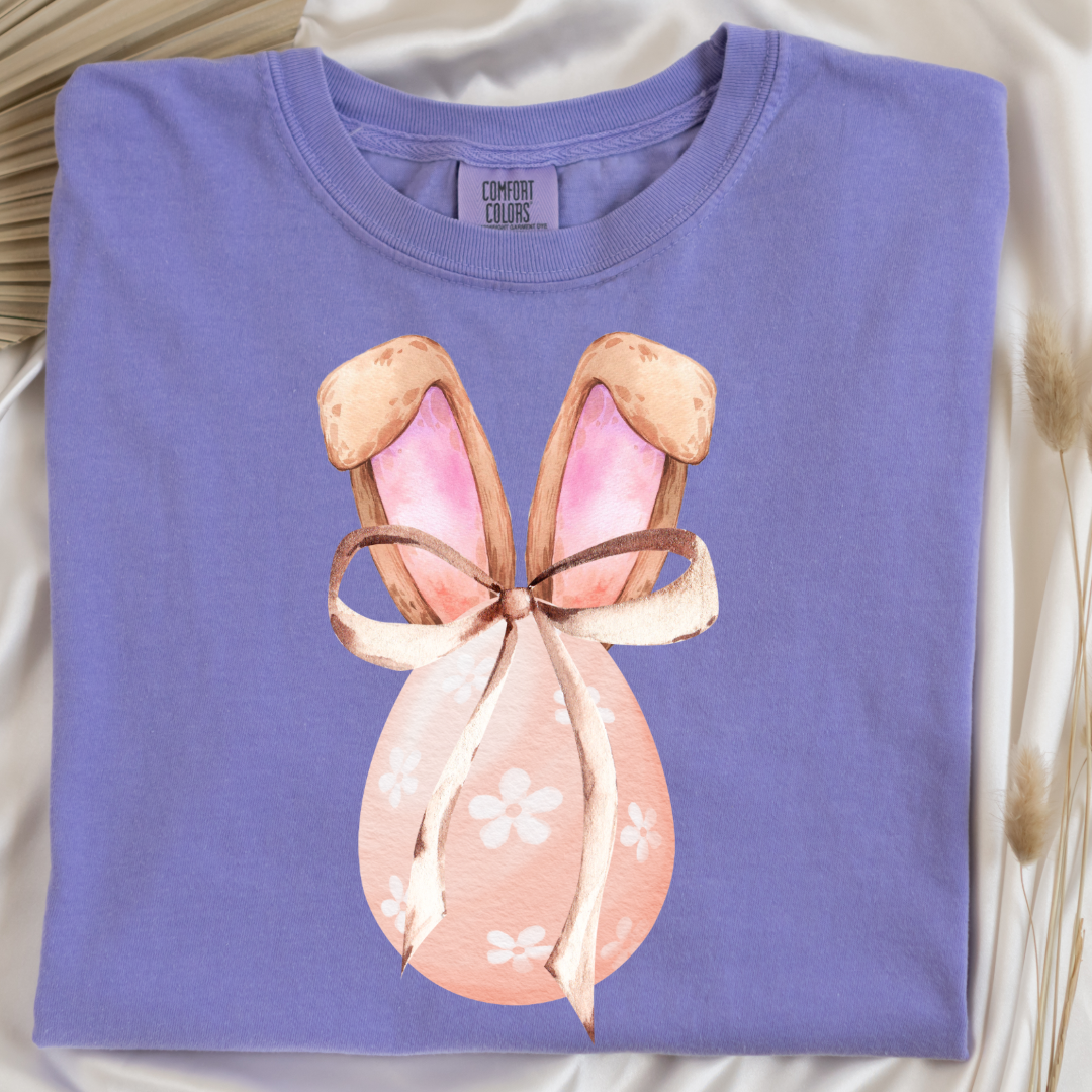 Customized adult comfort colors violet watercolor peach egg with white flowers and brown floppy skinny bow and bunny ears matching crewneck and hoodies available In adult and youth sizes