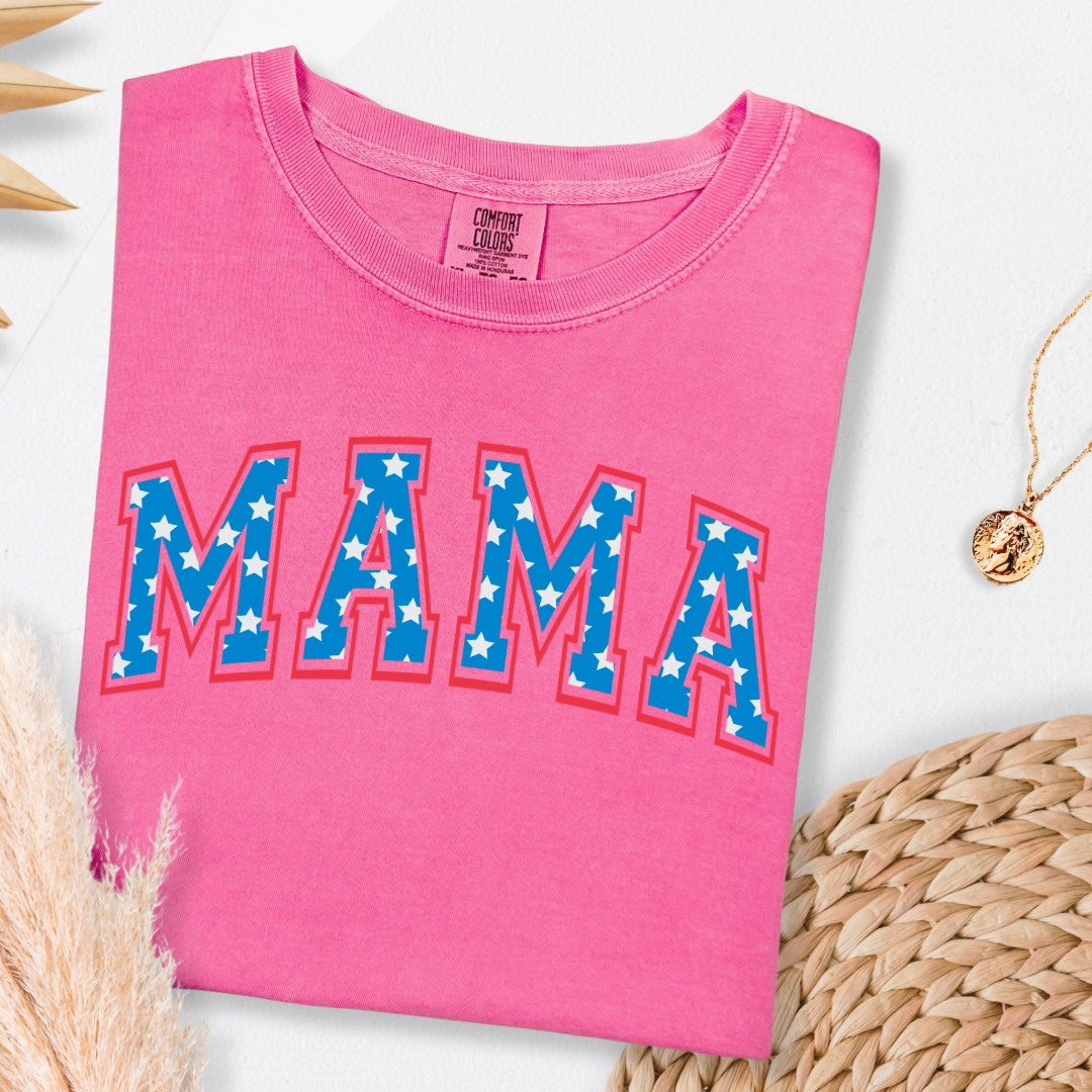 Customized adult Comfort Colors Crunchberry Graphic Tee with Seasonal 4th of July University style Font MAMA blue with white stars outlined un red , This style is available in adult Graphic Tees as well as adult crewnecks and hoodies .Available In DAD, MAMA and MINI.