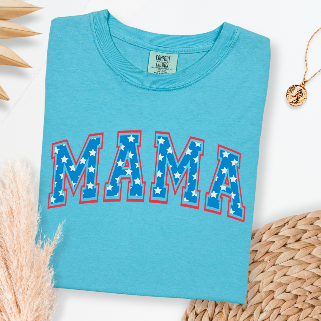 Customized adult Comfort Colors Lagoon Blue Graphic Tee with Seasonal 4th of July University style Font MAMA blue with white stars outlined un red , This style is available in adult Graphic Tees as well as adult crewnecks and hoodies .Available In DAD, MAMA and MINI.