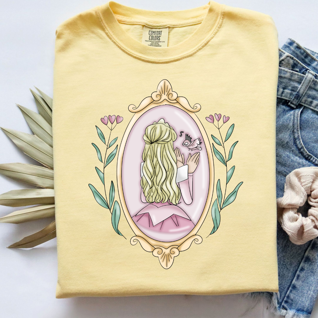 Customized comfort colorsbutter yellow Graphic tee Disney Princess sleeping beauty/Aurora back silhouette in a gold mirror with flower vines up the side. Designs are available in Adult and youth graphic tees as well as youth and adult crewnecks and adult hoodies. 
