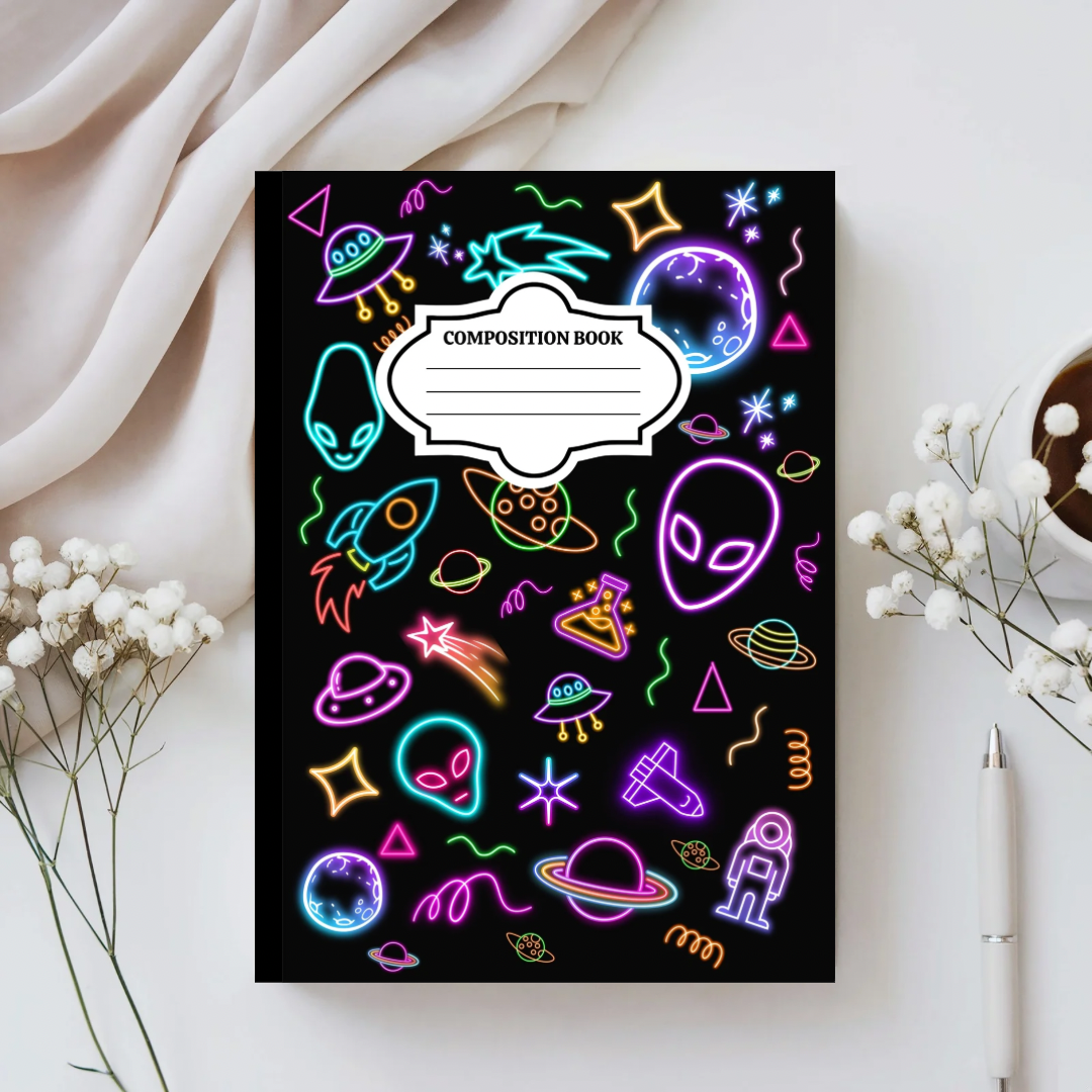 Composition book with neon space-themed illustrations on a white surface with flowers and a pen.