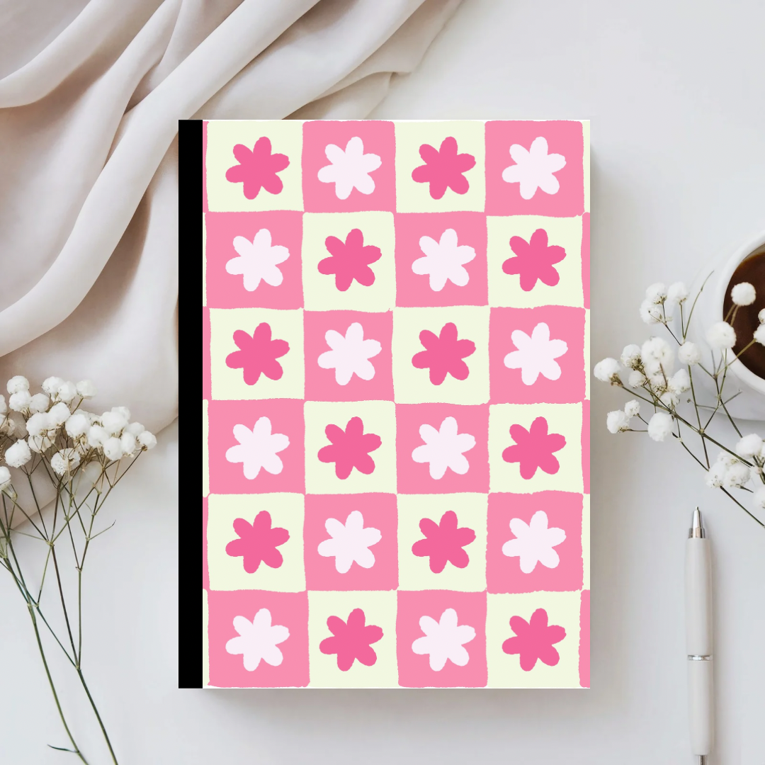 Notebook with pink and white floral pattern on a light background