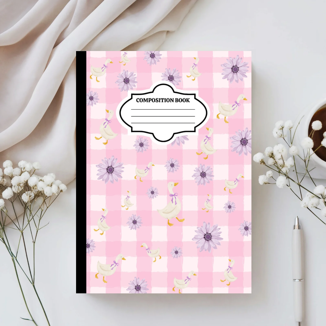 Composition book with floral pattern on a light background