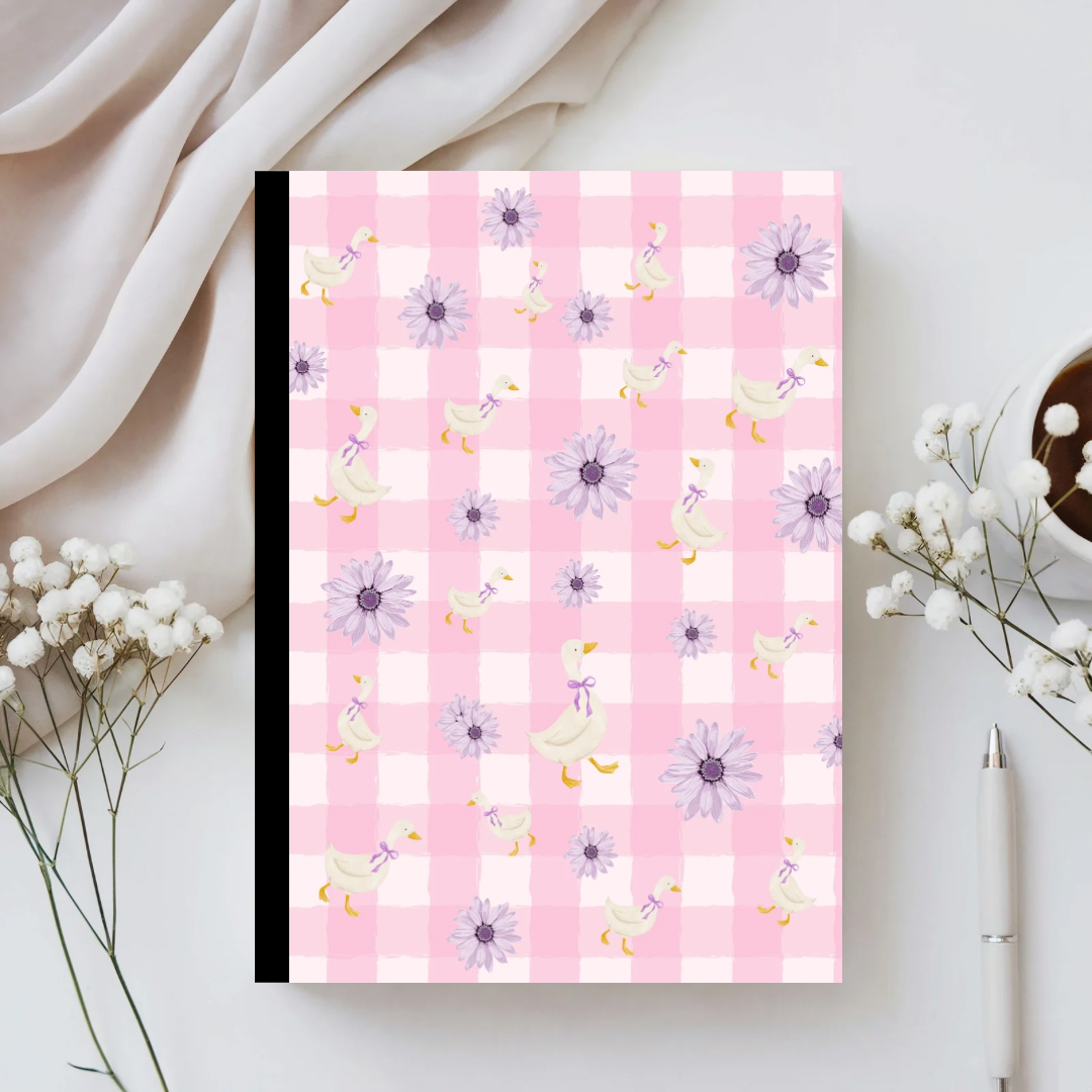 Notebook with pink and white checkered pattern and floral design on a light background