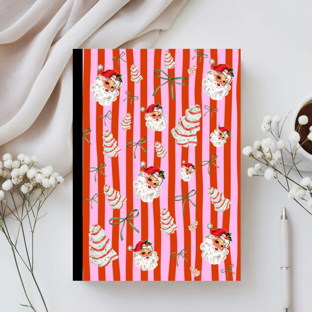 Notebook with Santa Claus and cake pattern on red and pink striped background