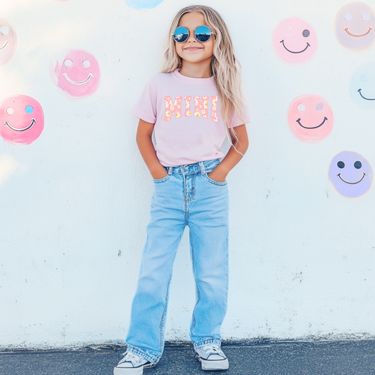 Customized Youth Blossom Pink Graphic tee with varsity letter font Mini with yellow and pink daisies Matching mama tee and crewneck available. 