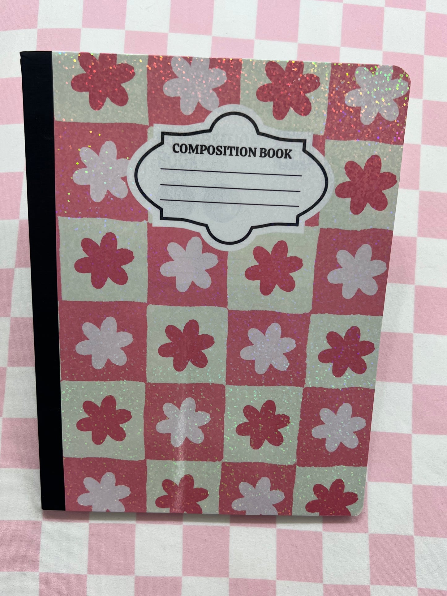 Composition book with floral pattern on a checkered background