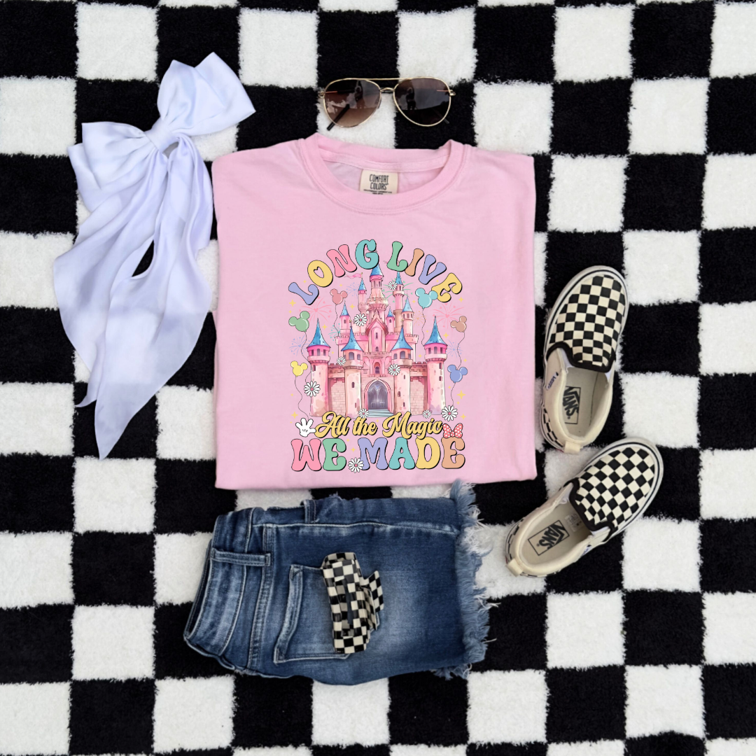 Customized Youth comfort colors blossom pink flat lay t-shirt with long live multi color long live bubble letters large castle in the middle with Mickey Mouse shaped balloons and flowers surrounding. Matching crewnecks and hoodies available in youth and adult sizes 