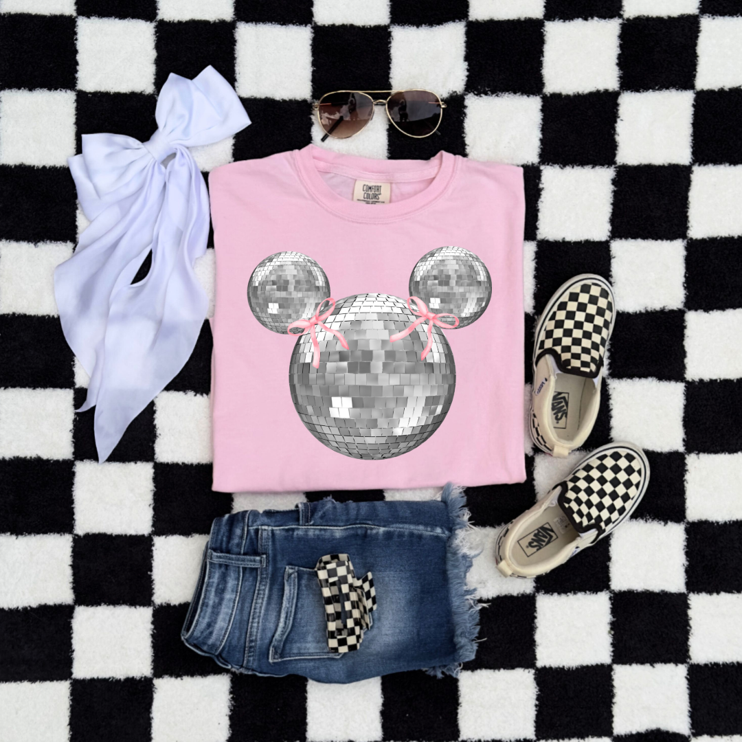 Customized Youth Comfort Colors Blossom Pink Graphic Tee Flat Lay Folded Disco Mickey head with pink bows on ears. Matching hoodies and crewnecks in Youth and adult sizes. 