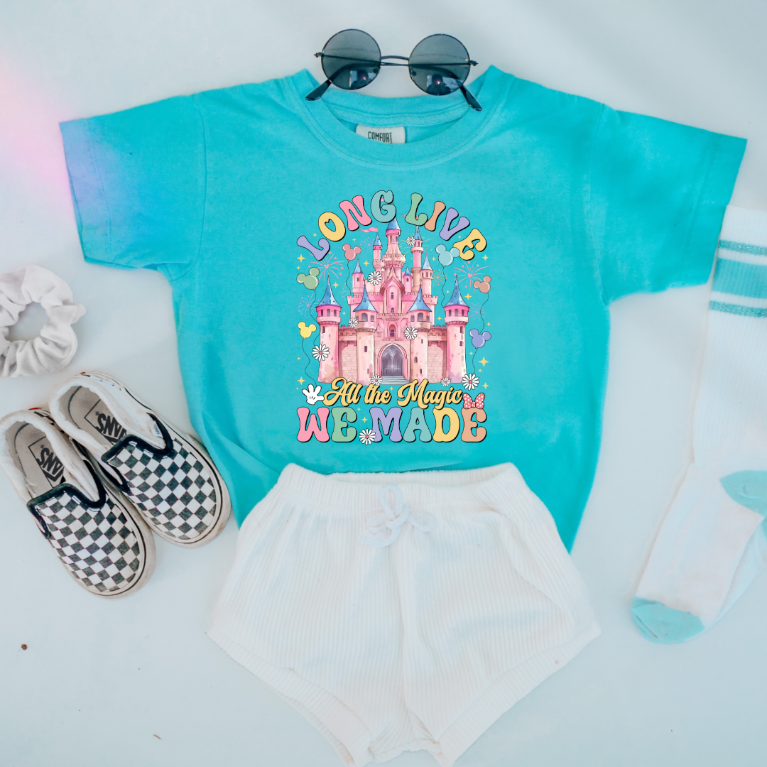 Customized Youth comfort colors Lagoon blue t-shirt with long live multi color long live bubble letters large castle in the middle with Mickey Mouse shaped balloons and flowers surrounding. Matching crewnecks and hoodies available in youth and adult sizes 