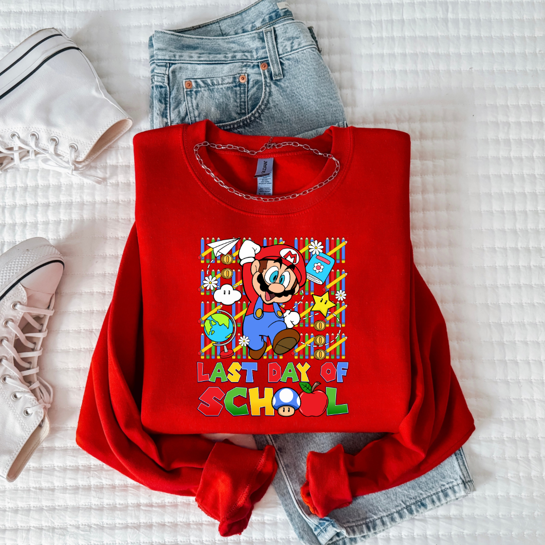 Customized Youth red comfort colors graphic tee. Last day of school Mario Nintendo world bubble letter font. With clouds Matching graphic tees available in youth sizing