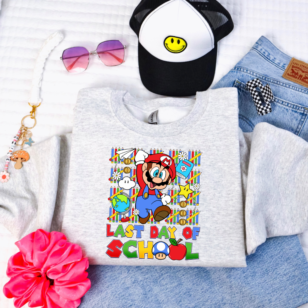 Customized Youth Grey comfort colors graphic tee. Last day of school Mario Nintendo world bubble letter font. With clouds Matching graphic tees available in youth sizing
