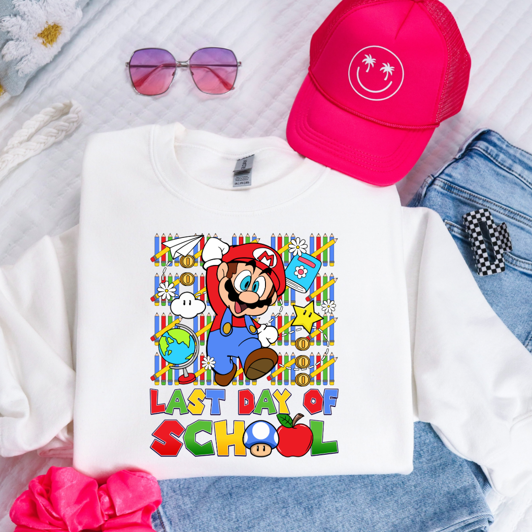 Customized Youth white comfort colors graphic tee. Last day of school Mario Nintendo world bubble letter font. With clouds Matching graphic tees available in youth sizing
