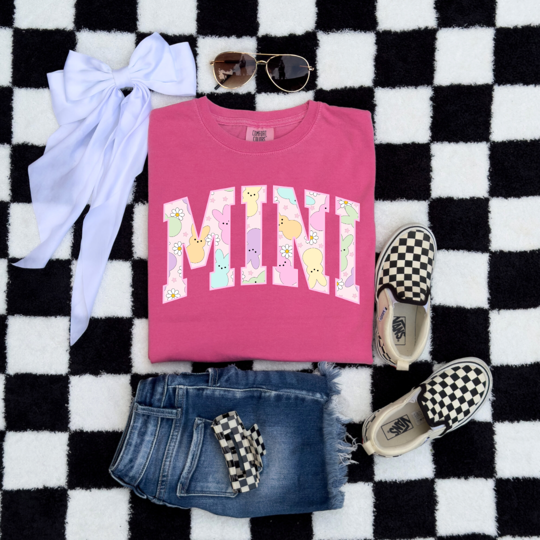 Customized youth mini of a mama and mini matching set varsity lettering with Patel peeps on the inside of the lettering matching youth crewneck available comfort colors crunchberry pink graphic tee 