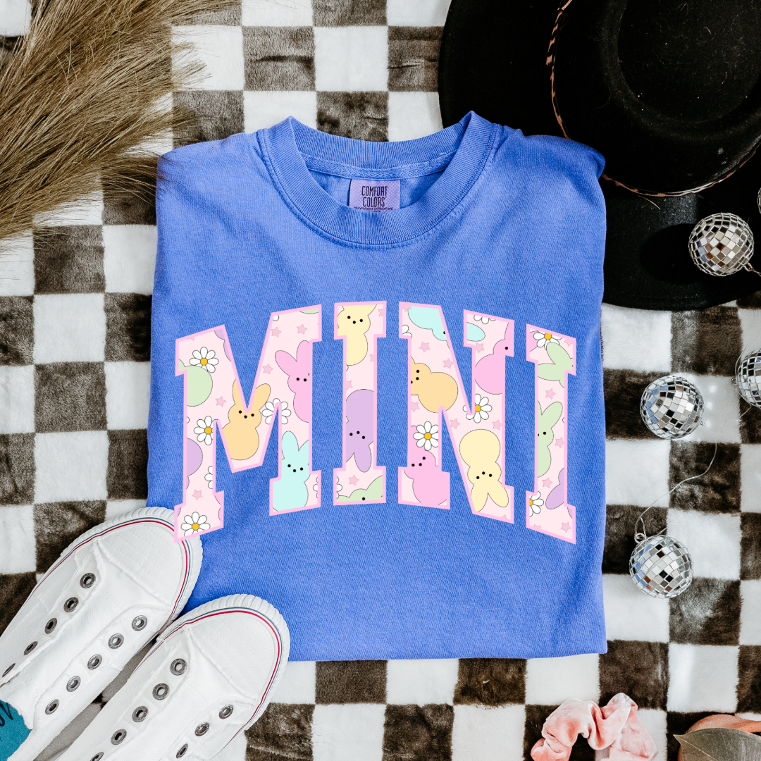 Customized youth mini of a mama and mini matching set varsity lettering with Patel peeps on the inside of the lettering matching youth and adult crewnecks available comfort colors flo blue graphic tee 