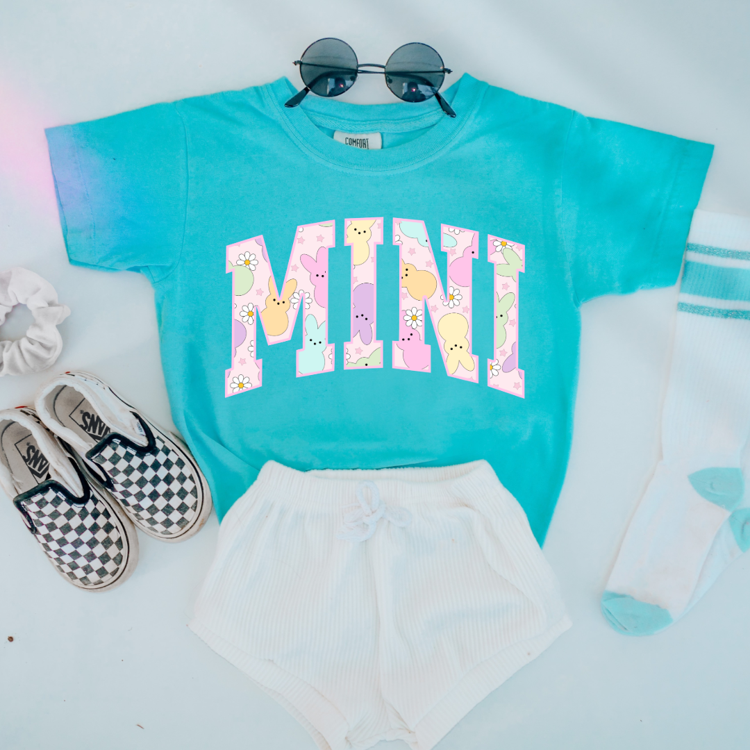 Customized youth mini of a mama and mini matching set varsity lettering with Patel peeps on the inside of the lettering matching youth crewnecks available comfort colors lagoon blue graphic tee 