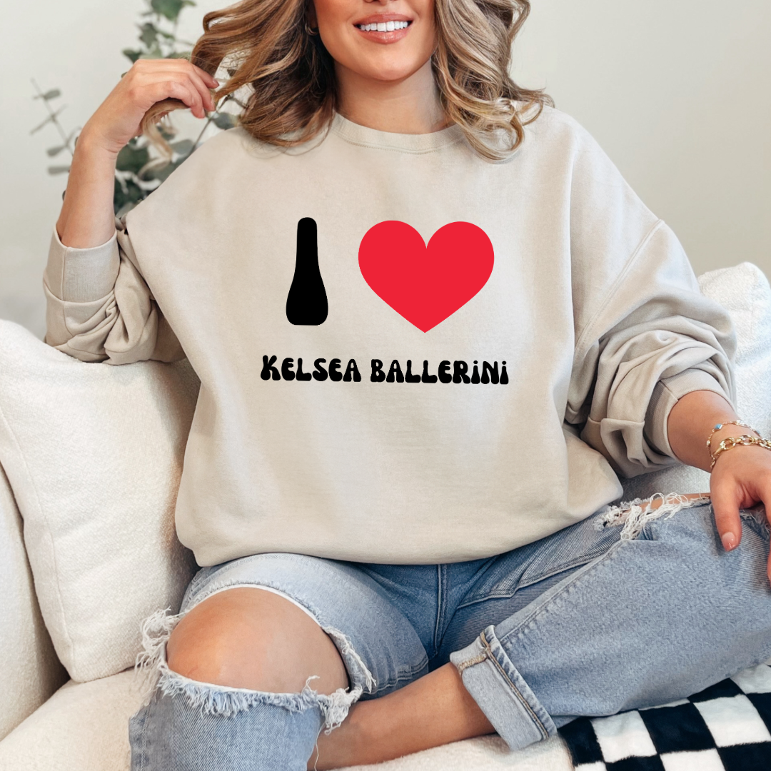 Customized Adult beige Crewneck with black groovy bubble letters I red heart Kelsea Ballerini. Matching crewneck and hoodies available in youth and adult sizing.