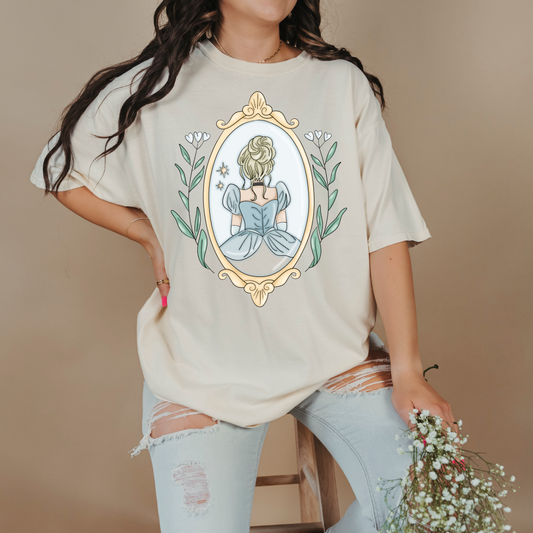 Customized comfort colors Ivory Graphic tee Disney Princess Cinderella back silhouette in a gold mirror with flower vines up the side. Designs are available in Adult and youth graphic tees as well as youth and adult crewnecks and adult hoodies. 
