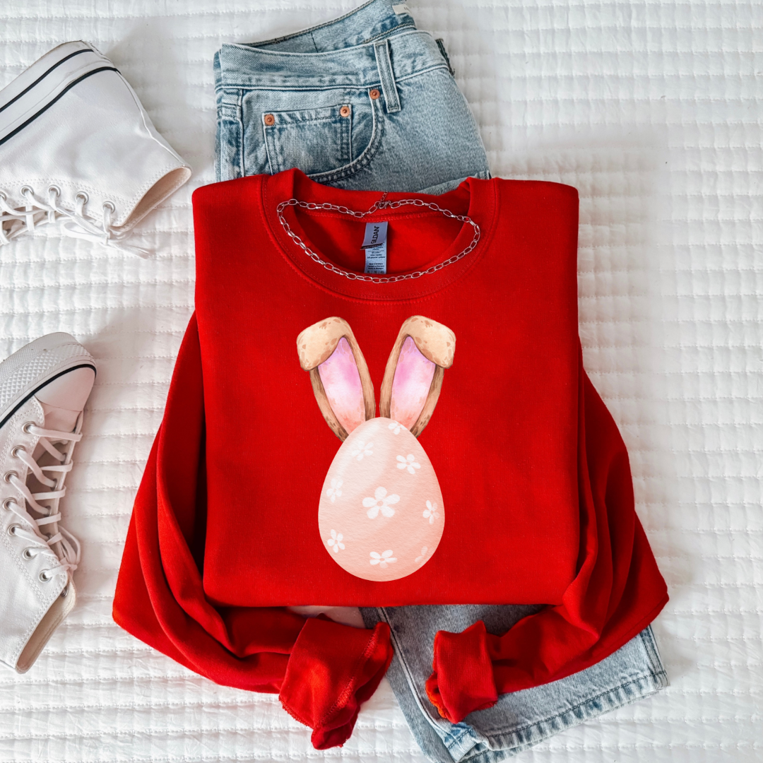 Customized youth red crewneck watercolor peach egg with white flowers and bunny ears matching tees and hoodies available In adult and youth sizes 