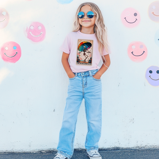 Customized Swiftie Youth comfort Colors Blossom Pink Graphic Tee with Skeleton Tarot Card on the front under an umbrella with the quote "Shade never made anybody less gay" Taylor Swift Quote Great for Pride month or Eras tour. Matching Adult and Youth Crewnecks and graphic tees available. 
