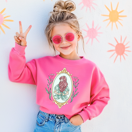 Customized youth hot pink Crewneck Disney Princess Ariel back silhouette in a gold mirror with flower vines up the side. Designs are available in Adult and youth graphic tees as well as youth and adult crewnecks and adult hoodies.