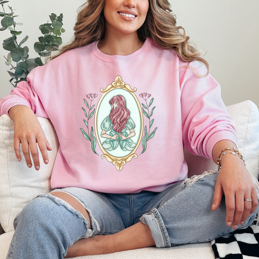 Customized adult Light pink Crewneck Disney Princess Ariel back silhouette in a gold mirror with flower vines up the side. Designs are available in Adult and youth graphic tees as well as youth and adult crewnecks and adult hoodies. 